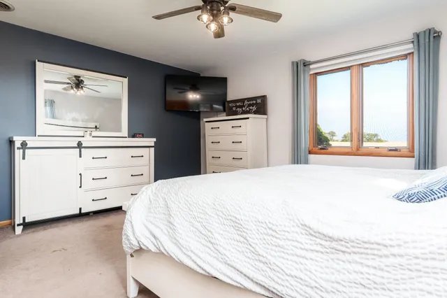 a bedroom with a bed and a window