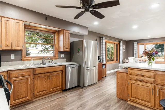 a kitchen with stainless steel appliances granite countertop a stove and a refrigerator