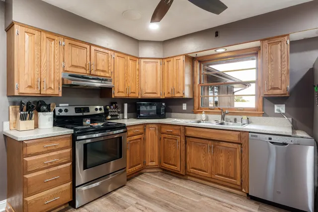 a kitchen with stainless steel appliances granite countertop a stove and a refrigerator