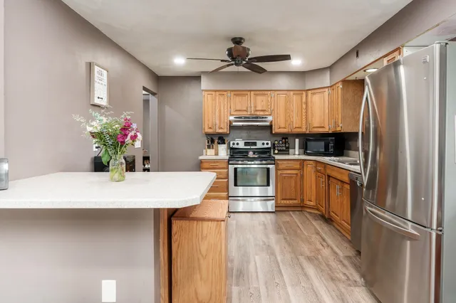 a kitchen with refrigerator and a table