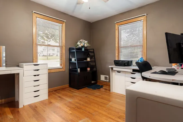 a view of a workspace with furniture and a flat screen tv