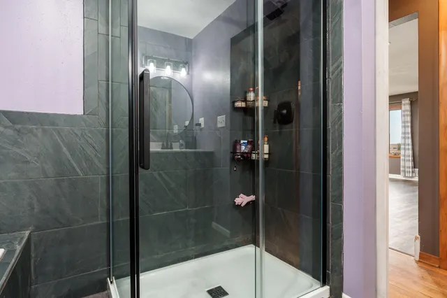 a spacious bedroom with a bed and a large window