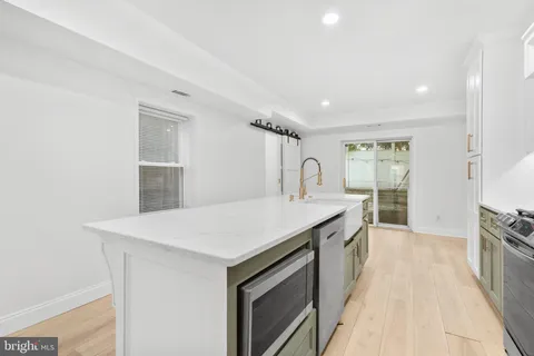 a kitchen with a sink a stove and a refrigerator