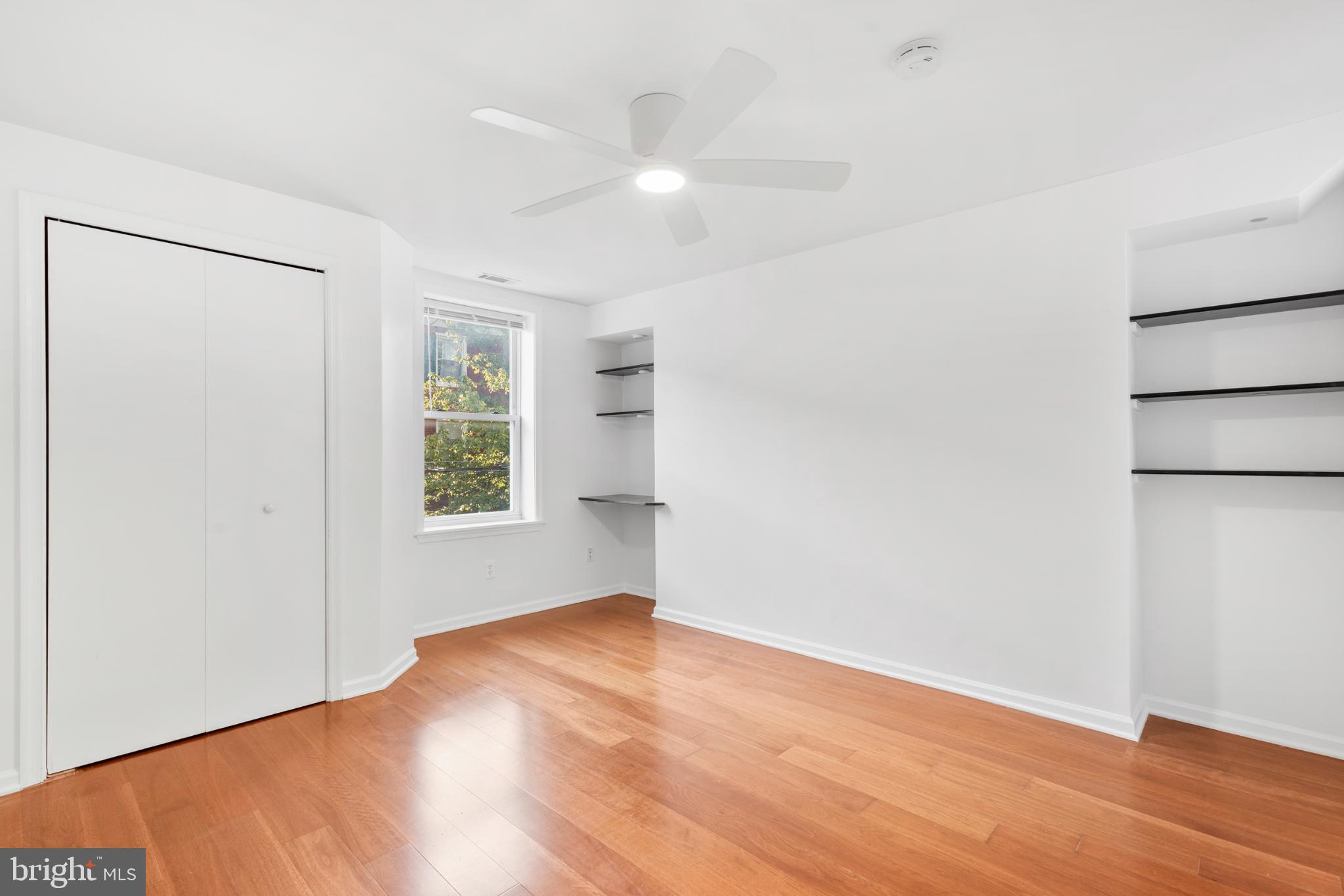 944 North Randolph Street Philadelphia, PA 19123 - Photo 19 of 26 an empty room with wooden floor and windows