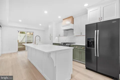 a kitchen with refrigerator a sink and cabinets