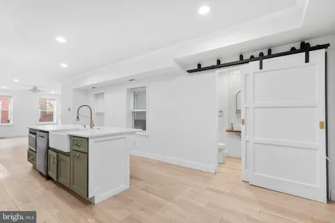 a view of kitchen with sink microwave and refrigerator