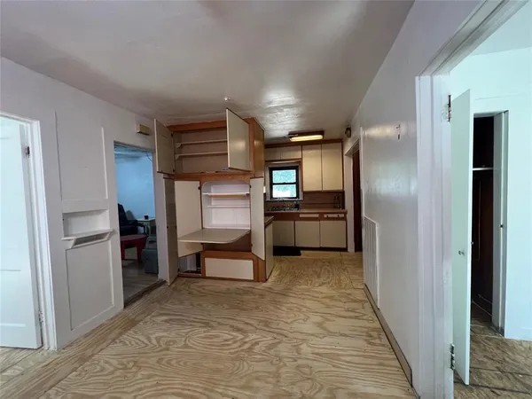 a kitchen with refrigerator and cabinets