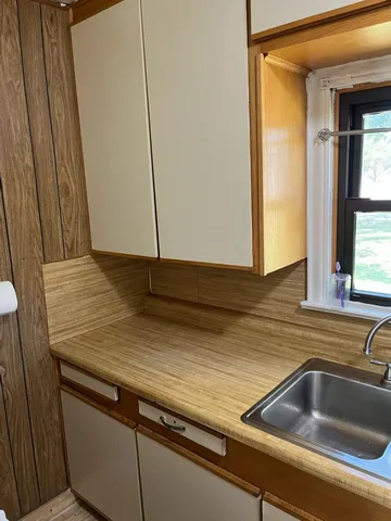 a kitchen with a sink and a window