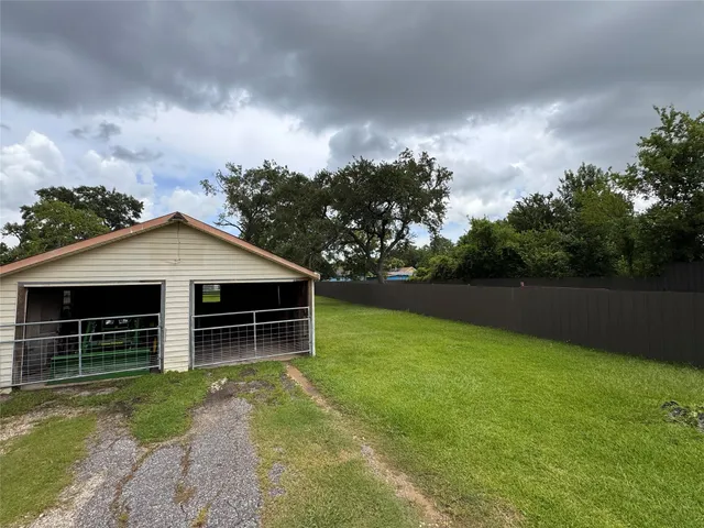 a view of house with backyard and garden