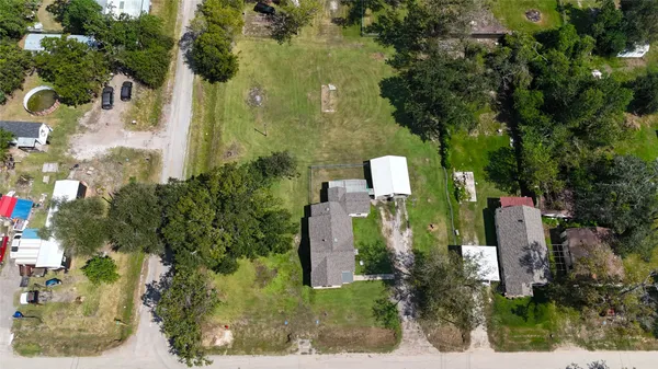 an aerial view of a house with a yard basket ball court and outdoor seating