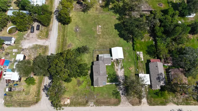 an aerial view of a house with a yard basket ball court and outdoor seating