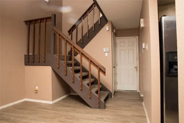 a view of entryway with wooden floor and stairs