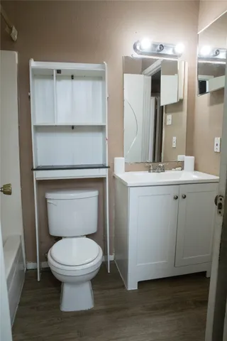 a white toilet sitting next to a bathroom sink