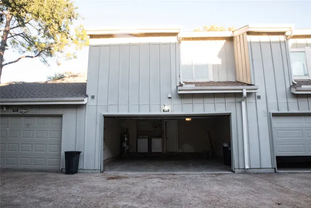 a view of a house with a garage and balcony