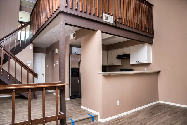 a view of entryway with wooden floor and stairs