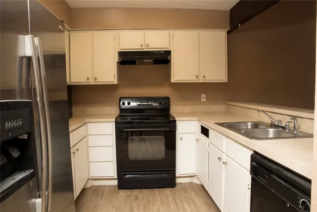 a kitchen with a sink stove and refrigerator