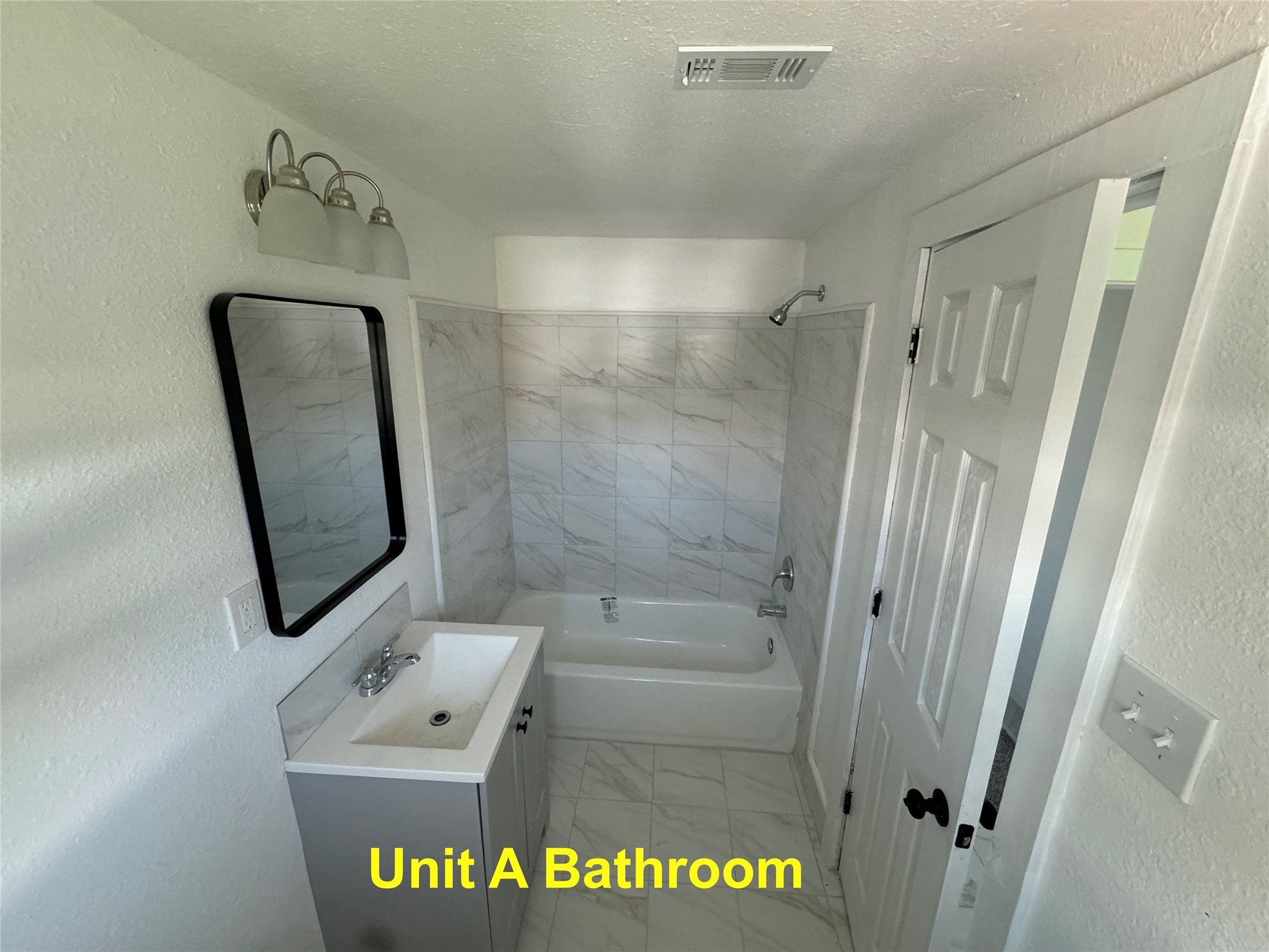 8214 Livingston Street, Unit A Houston, TX 77051 - Photo 2 of 17 a bathroom with a shower and mirror