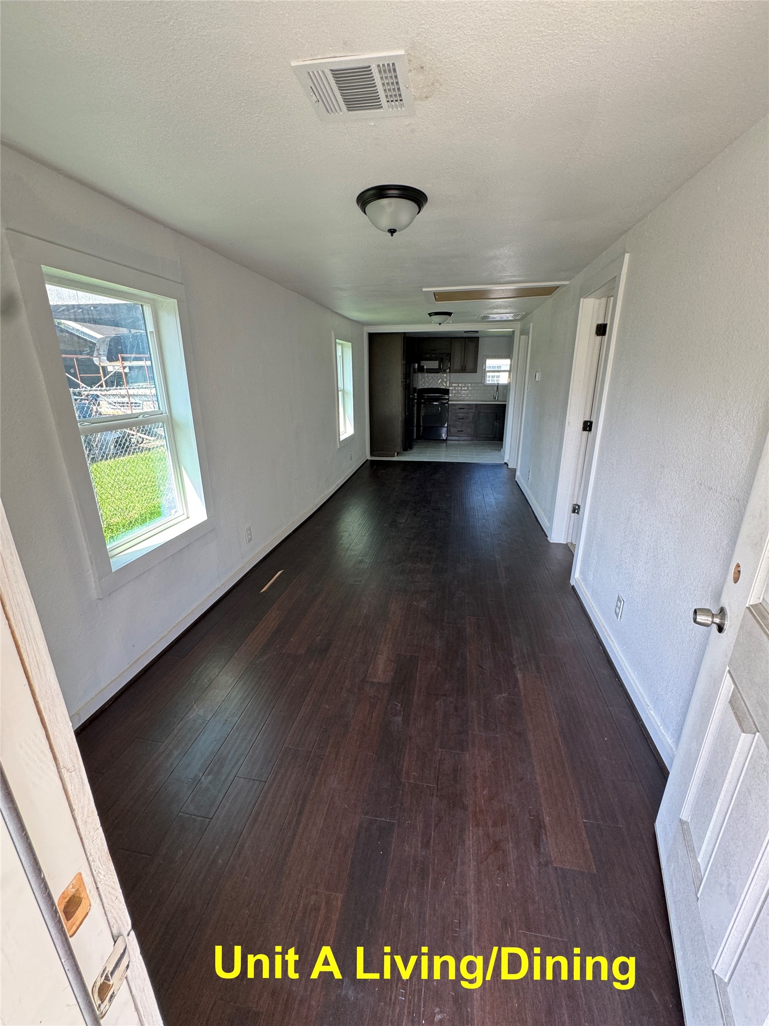 8214 Livingston Street, Unit A Houston, TX 77051 - Photo 3 of 17 a view of an empty room with wooden floor and a window