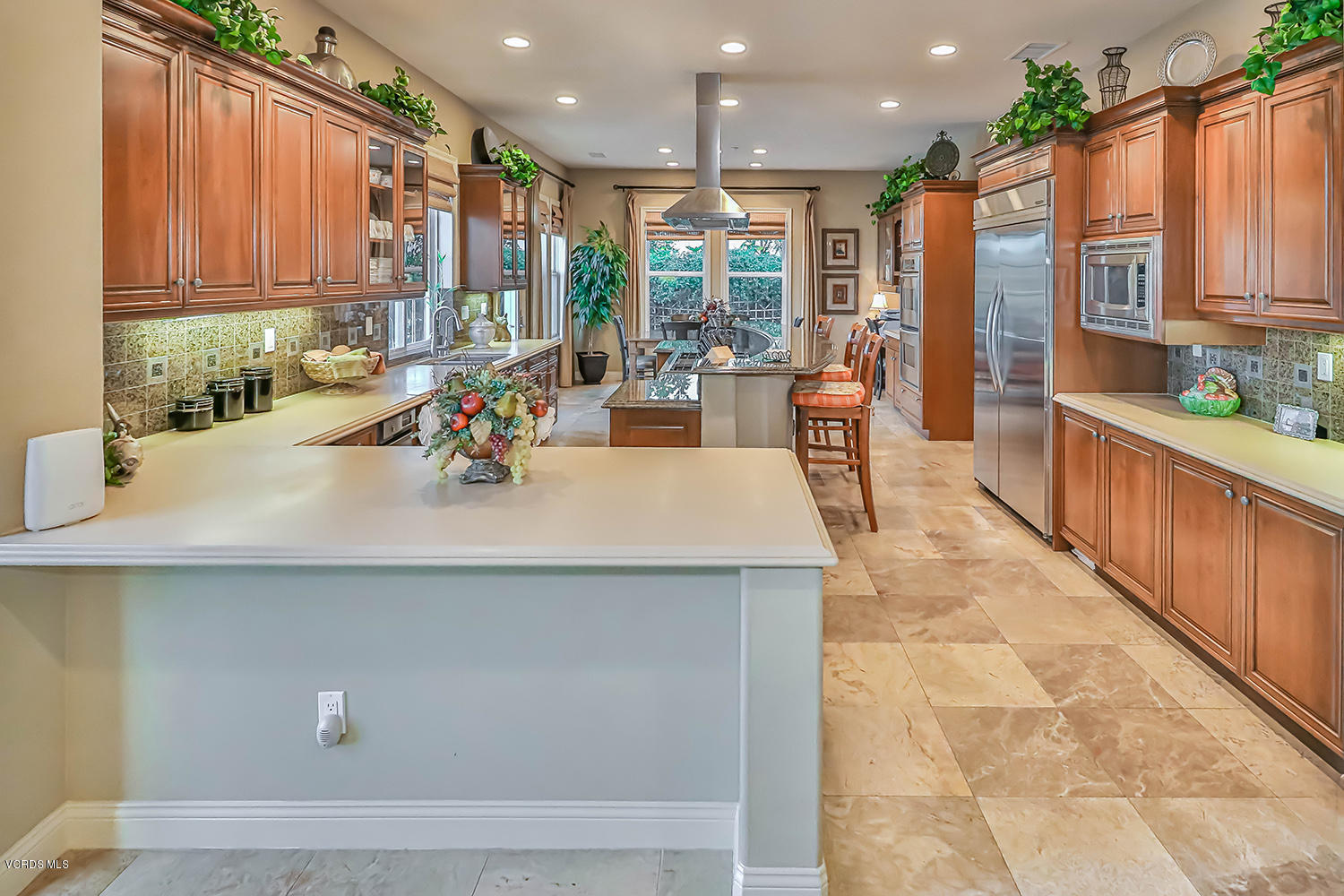457 Vineyard Drive Simi Valley, CA 93065 - Photo 18 of 65 a view of a kitchen with kitchen island a large window a sink and cabinets
