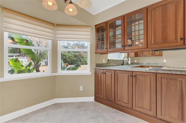 a kitchen with granite countertop a sink stove and refrigerator