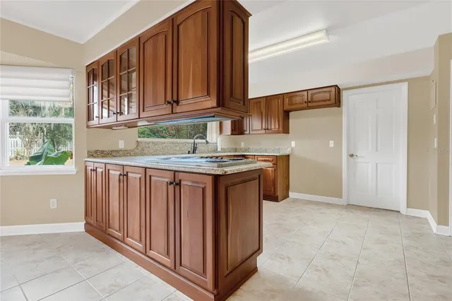 a kitchen with stainless steel appliances granite countertop a stove a sink and a microwave