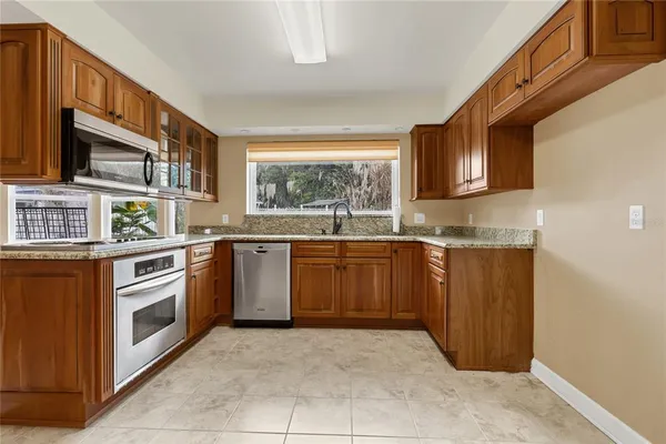 a kitchen with stainless steel appliances granite countertop a sink and cabinets