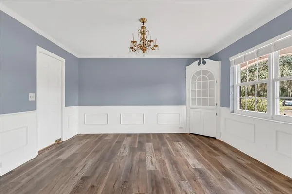 a view of entryway and hall with wooden floor
