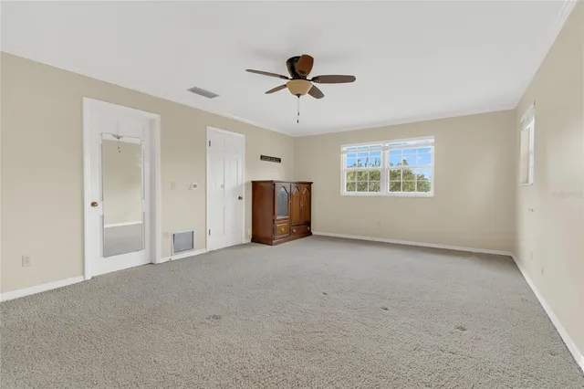 a bathroom with a granite countertop toilet sink and mirror