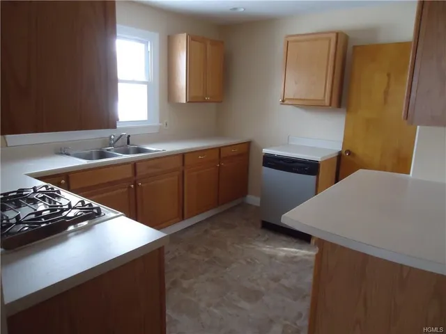 a kitchen with stainless steel appliances a sink stove and cabinets