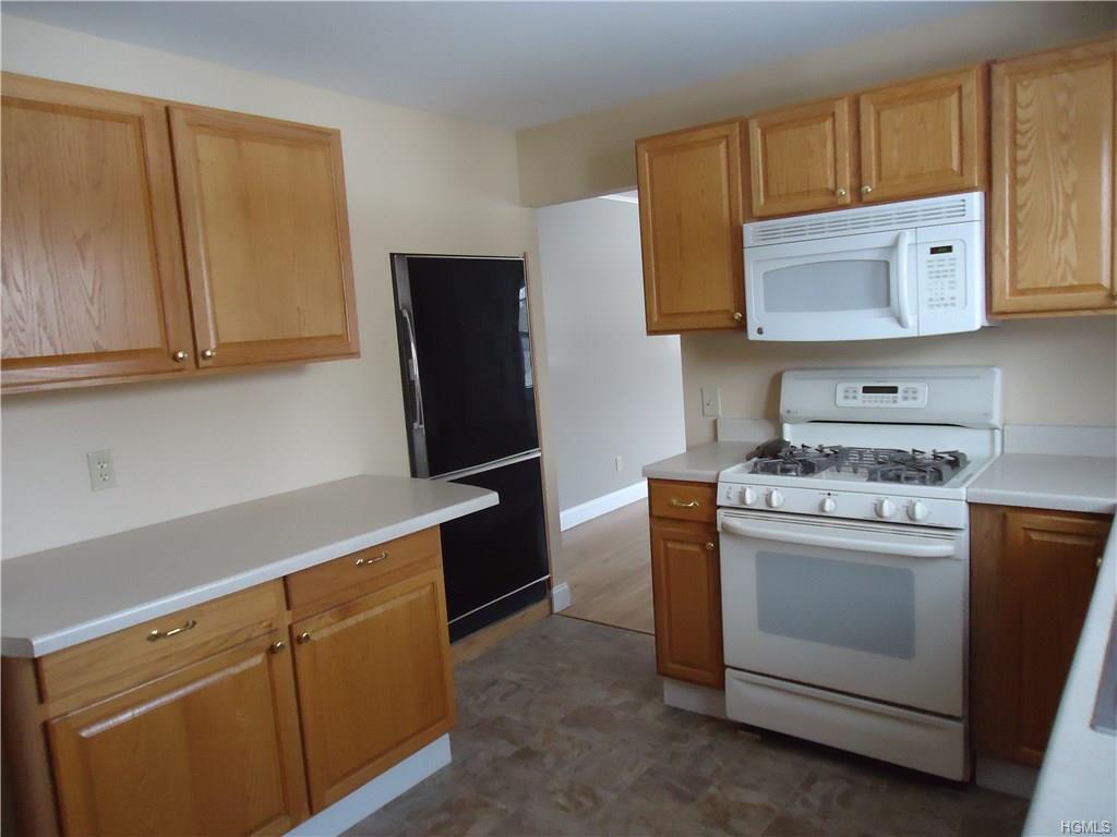 56-58 Still Road Monroe, NY 10950 - Photo 10 of 18 a kitchen with appliances cabinets and a counter top space