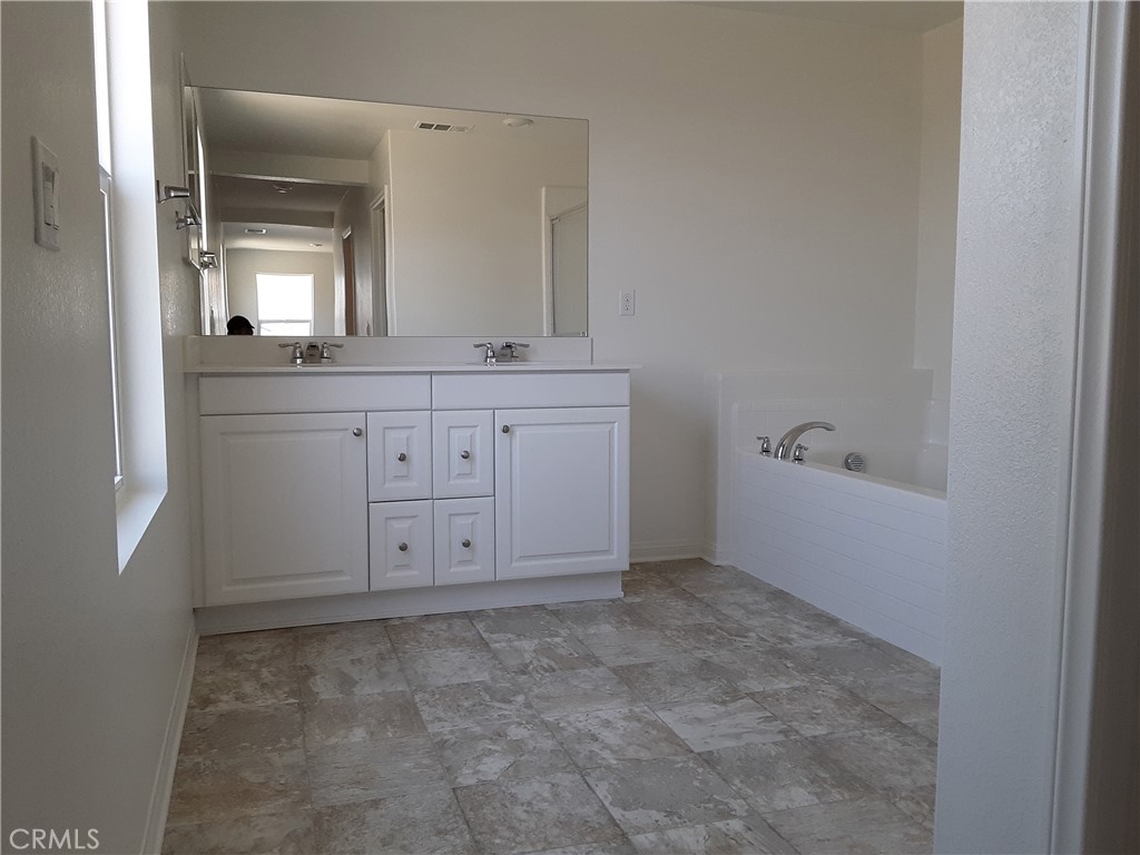 21108 Bison Mesa Road Riverside, CA 92507 - Photo 13 of 45 a bathroom with a granite countertop sink and a mirror