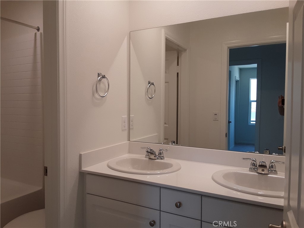 21108 Bison Mesa Road Riverside, CA 92507 - Photo 24 of 45 a bathroom with a sink and a mirror