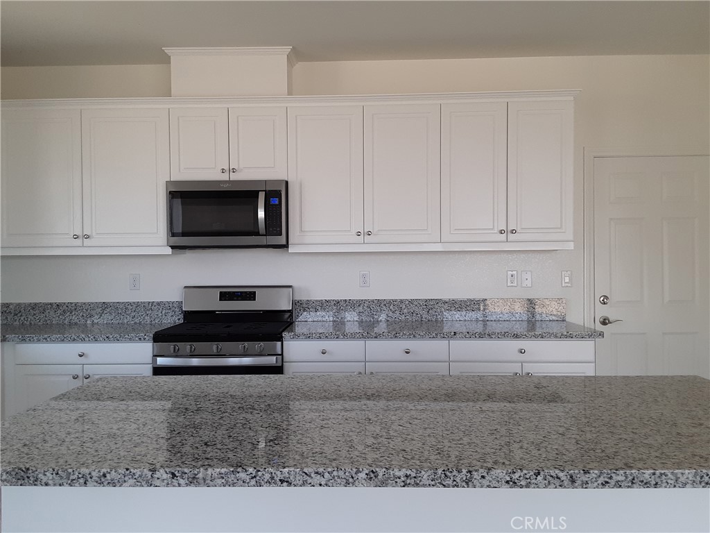 21108 Bison Mesa Road Riverside, CA 92507 - Photo 37 of 45 a kitchen with appliances a sink and cabinets