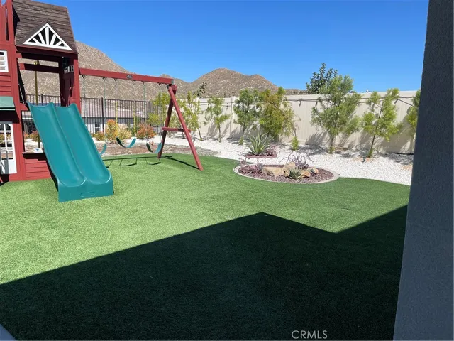 a view of a house with backyard and a patio