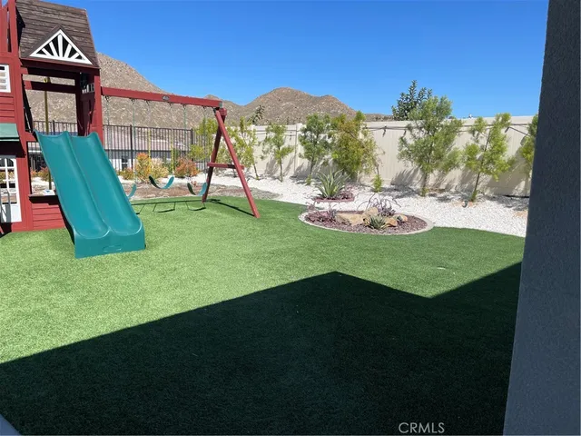 a view of a house with backyard and a patio