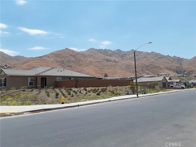 a view of a house with a street from a balcony