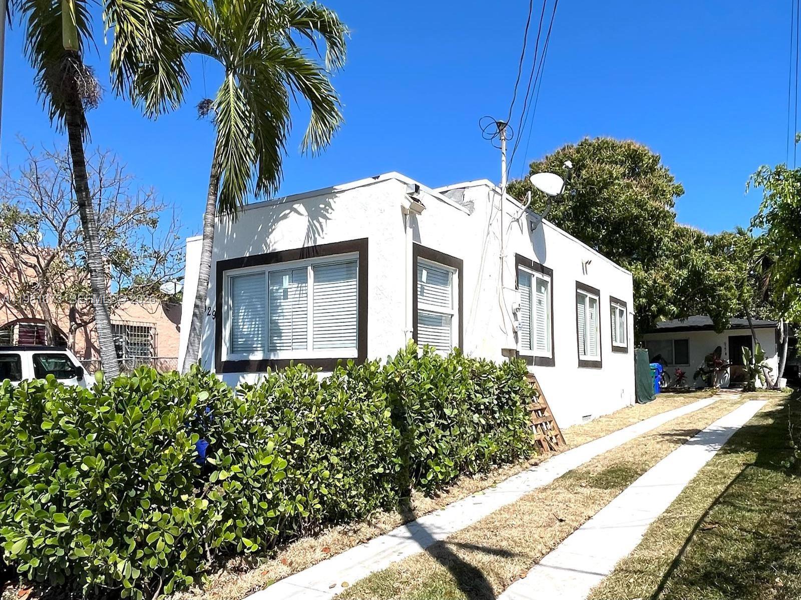 929 Southwest 12th Avenue, Unit 929 Miami, FL 33130 - Photo 2 of 18 a front view of a house with a yard