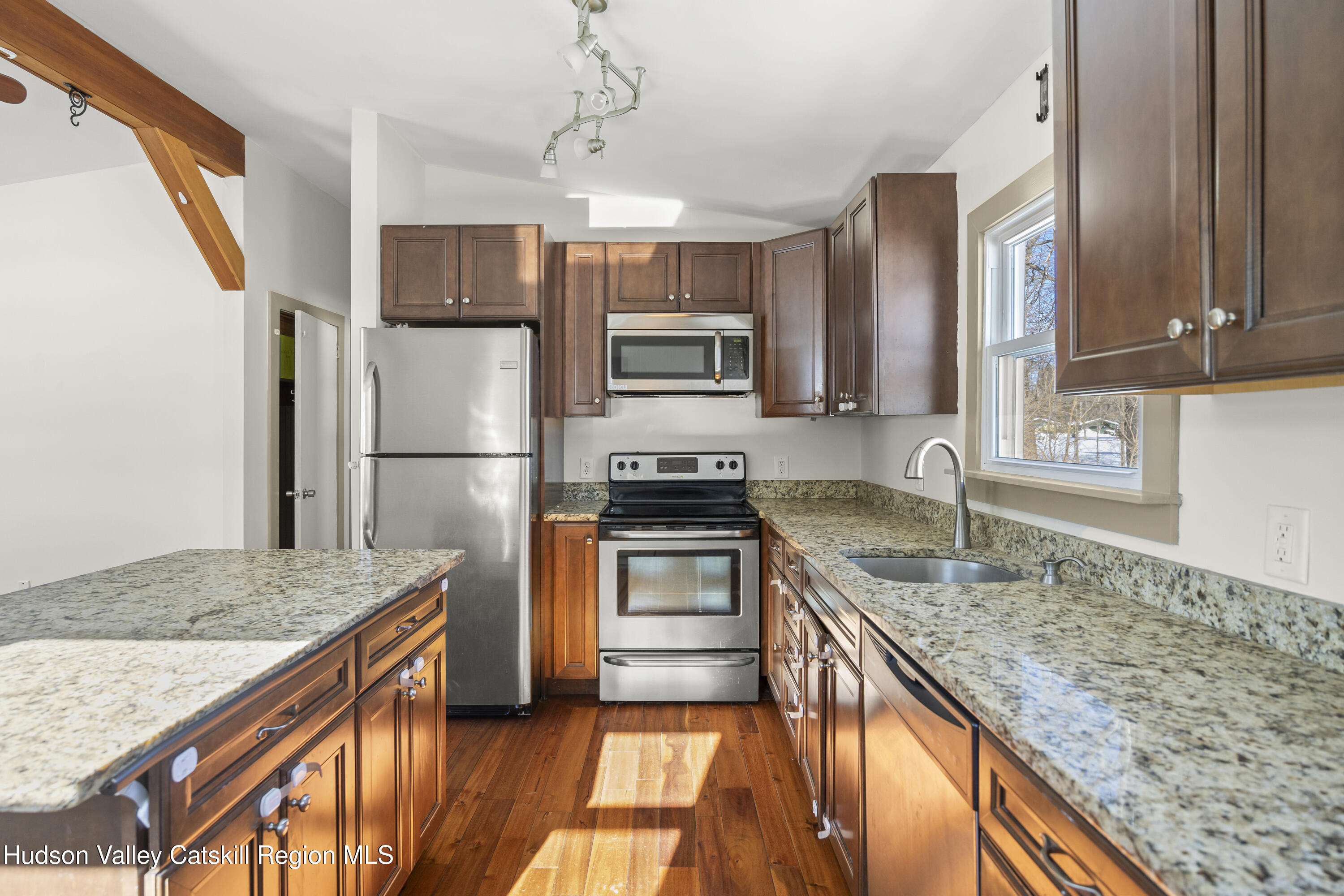 116 Lincoln Road Copake, NY 12516 - Photo 10 of 20 a kitchen with granite countertop stainless steel appliances and wooden cabinets