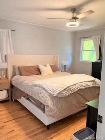 a bedroom with a bed a window and lamps