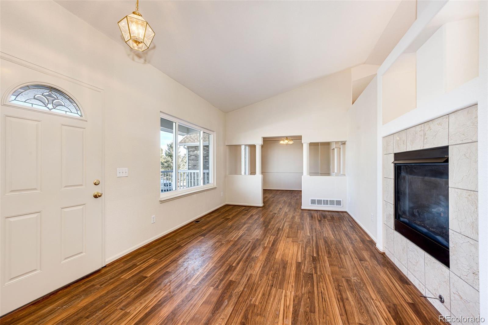 5672 Columbine Ridge Road Elizabeth, CO 80107 - Photo 15 of 50 a view of an empty room with wooden floor and a window