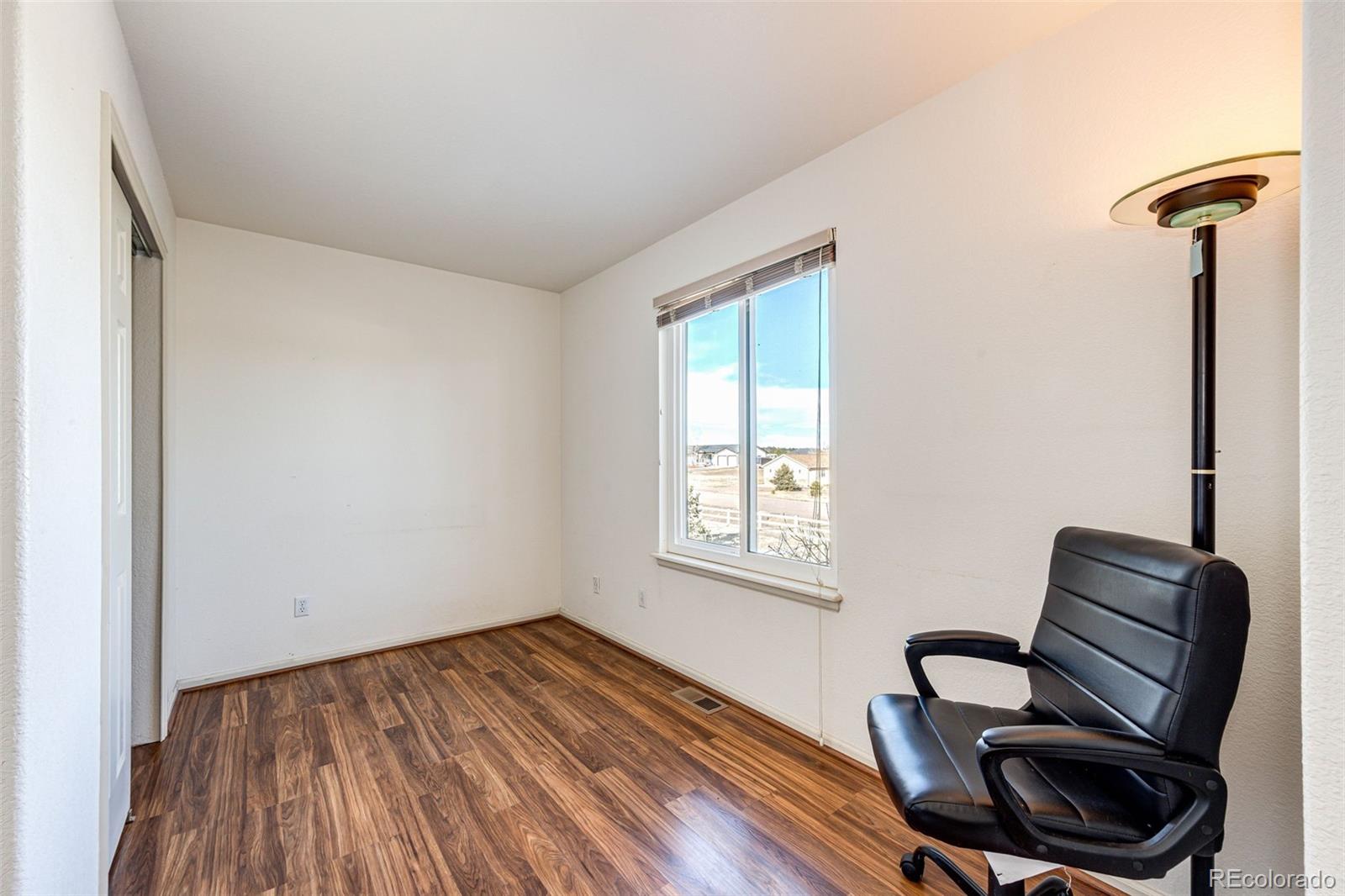 5672 Columbine Ridge Road Elizabeth, CO 80107 - Photo 31 of 50 a view of room with furniture and wooden floor