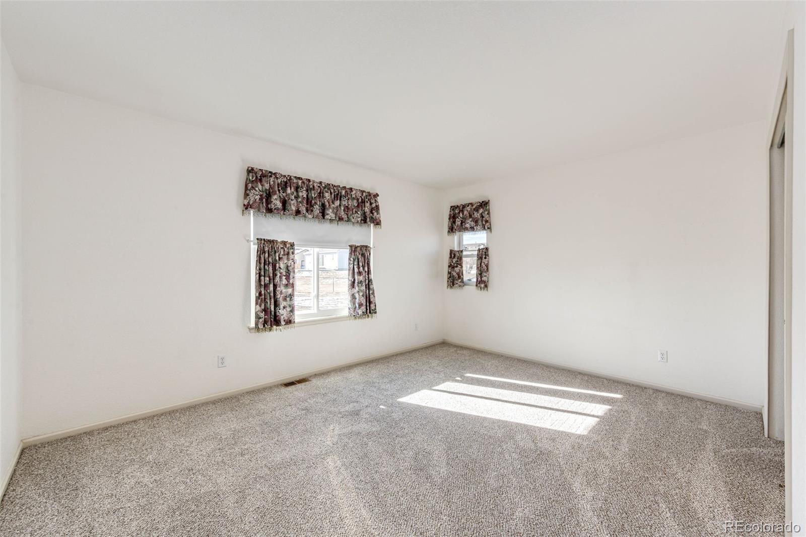 5672 Columbine Ridge Road Elizabeth, CO 80107 - Photo 33 of 50 an empty room with windows