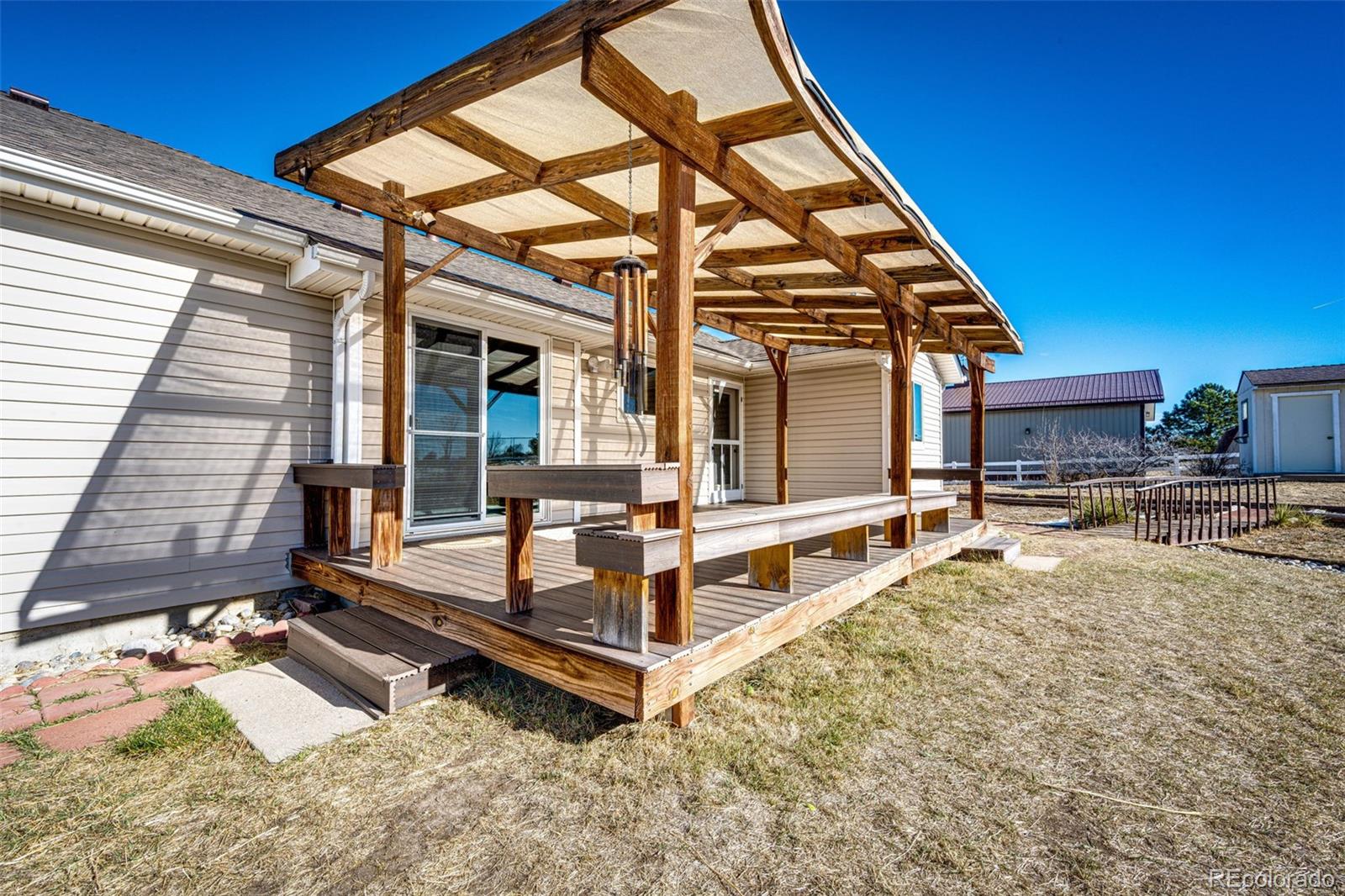 5672 Columbine Ridge Road Elizabeth, CO 80107 - Photo 40 of 50 a view of a house with backyard and porch