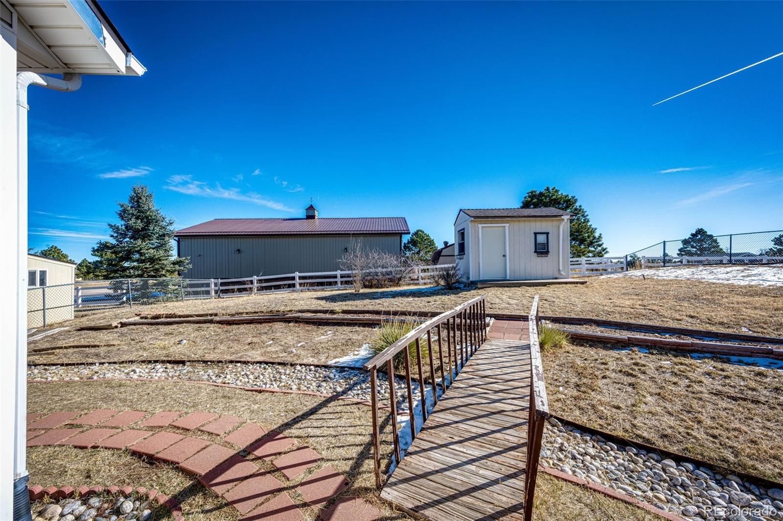 5672 Columbine Ridge Road Elizabeth, CO 80107 - Photo 41 of 50 a view of a balcony with two chairs and a potted plant