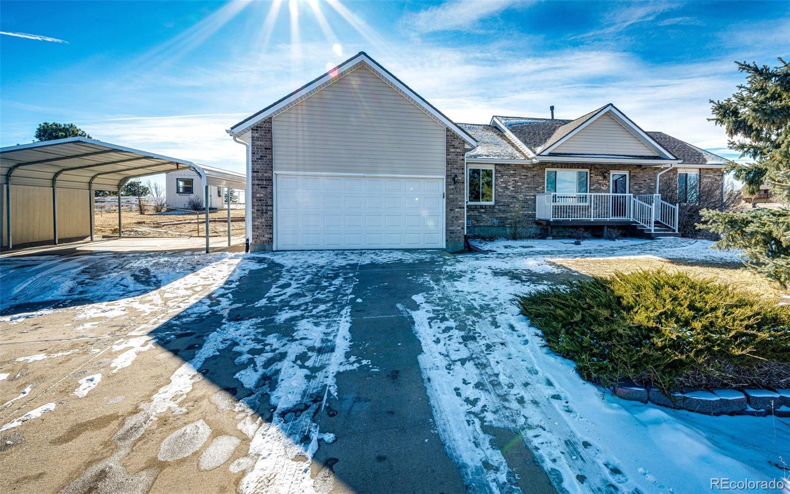 5672 Columbine Ridge Road Elizabeth, CO 80107 - Photo 10 of 50 a front view of a house with a garden