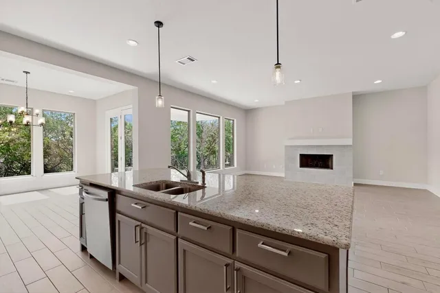 a kitchen with a sink stainless steel appliances a counter space and cabinets