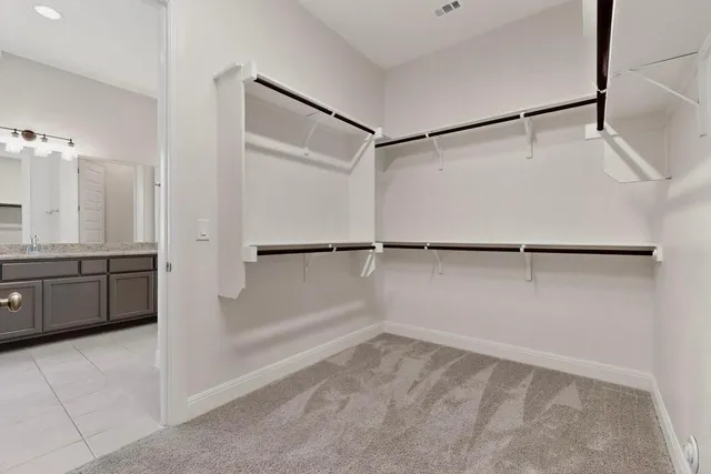 a spacious bedroom with a large bed and a large window