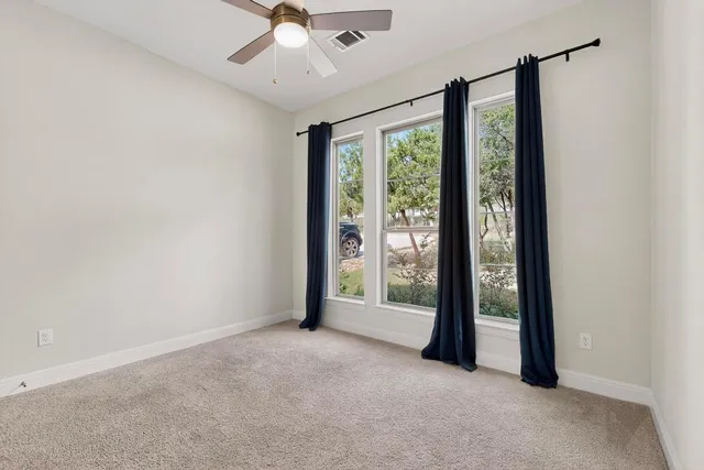 a bathroom with a granite countertop bathtub a sink and a mirror
