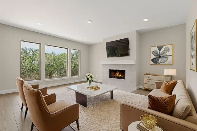 a living room with furniture fireplace and window
