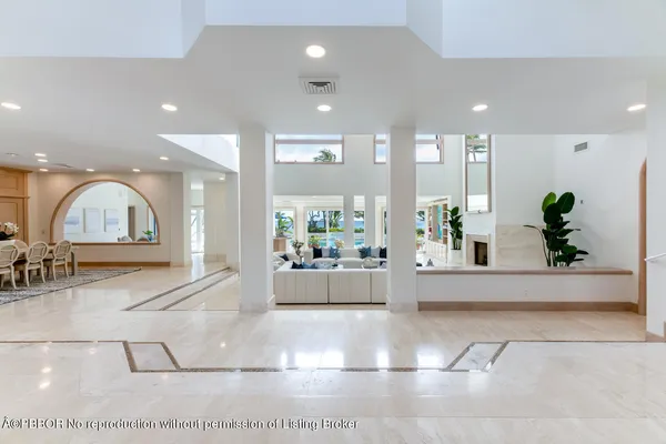 a living room with furniture fireplace and a large window